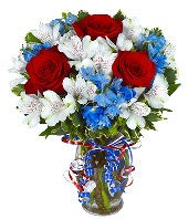 Red roses, white alstroemeria and blue flowers for a patriotic arrangement